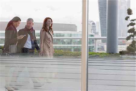 simsearch:6108-06166865,k - Business people walking on urban highrise balcony Stock Photo - Premium Royalty-Free, Code: 6113-08943725