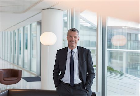 Portrait smiling businessman in office lounge Stock Photo - Premium Royalty-Free, Code: 6113-08943807