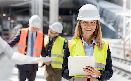simsearch:6113-08722278,k - Portrait smiling female engineer with clipboard at construction site Stock Photo - Premium Royalty-Free, Code: 6113-08943940