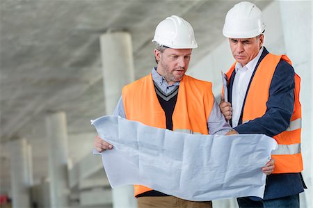 simsearch:632-03403433,k - Male engineers examining underground blueprints at construction site Stock Photo - Premium Royalty-Free, Code: 6113-08943922