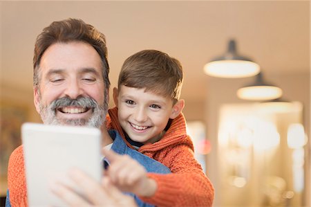 simsearch:6113-06908842,k - Father and son bonding, sharing digital tablet Stock Photo - Premium Royalty-Free, Code: 6113-08947245