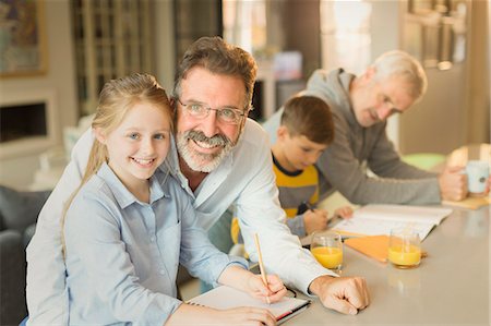 father son study - Portrait male gay parents helping children with homework at kitchen counter Stock Photo - Premium Royalty-Free, Code: 6113-08947280