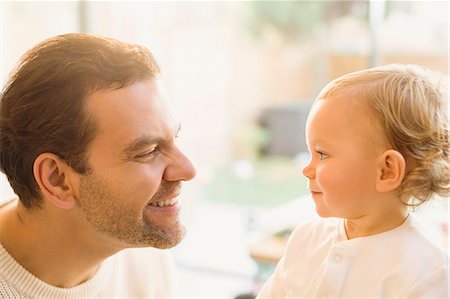 simsearch:6113-06626289,k - Father smiling at cute baby son Stock Photo - Premium Royalty-Free, Code: 6113-08947294