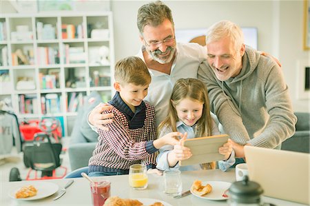 simsearch:6113-06908842,k - Male gay parents and children video messaging with digital tablet in morning kitchen Stock Photo - Premium Royalty-Free, Code: 6113-08947213