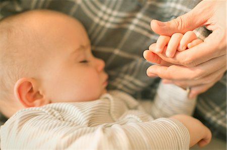 simsearch:614-07031844,k - Close up sleeping baby boy holding hands with father Stock Photo - Premium Royalty-Free, Code: 6113-08947215