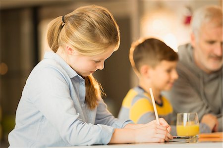 Girl doing homework at counter Stock Photo - Premium Royalty-Free, Code: 6113-08947222