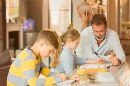 father son study - Male gay parents helping children with homework at counter Stock Photo - Premium Royalty-Free, Code: 6113-08947233