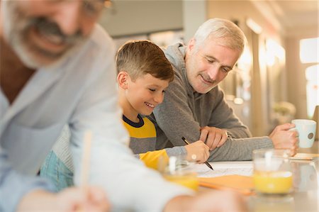 father son study - Father helping son with homework at counter Stock Photo - Premium Royalty-Free, Code: 6113-08947238