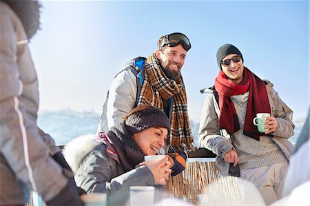 ski - Smiling skier friends drinking coffee and hot cocoa outside apres-ski Stock Photo - Premium Royalty-Free, Code: 6113-08947399