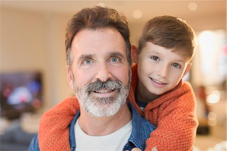simsearch:6113-06899473,k - Close up portrait smiling father and son hugging Stock Photo - Premium Royalty-Free, Code: 6113-08947304