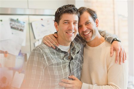 simsearch:614-08148673,k - Portrait smiling, affectionate male gay couple hugging in kitchen Stock Photo - Premium Royalty-Free, Code: 6113-08947314