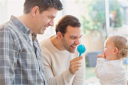 simsearch:625-02929316,k - Male gay parents and baby son playing with rattle Stock Photo - Premium Royalty-Free, Code: 6113-08947321