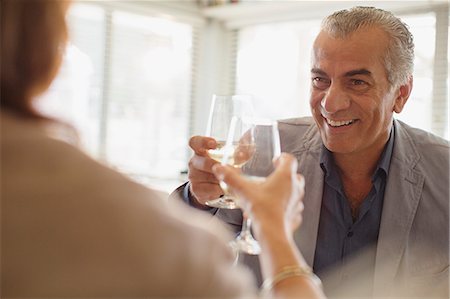 simsearch:6113-07242109,k - Smiling senior man drinking wine, toasting wine glasses with woman at restaurant Stock Photo - Premium Royalty-Free, Code: 6113-08985763