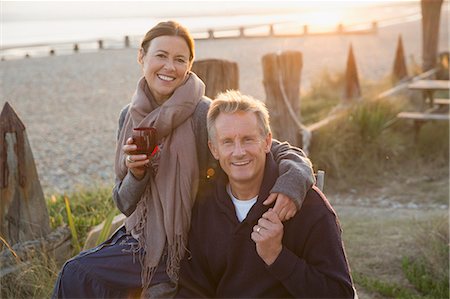 simsearch:6113-07790692,k - Portrait smiling mature couple holding hands and drinking wine on sunset beach Stock Photo - Premium Royalty-Free, Code: 6113-08985766