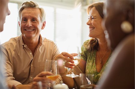 simsearch:6113-07242109,k - Laughing mature couple drinking wine at restaurant table Stock Photo - Premium Royalty-Free, Code: 6113-08985713
