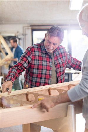 simsearch:6115-07109879,k - Male carpenters examining wood boat in workshop Stock Photo - Premium Royalty-Free, Code: 6113-08985871