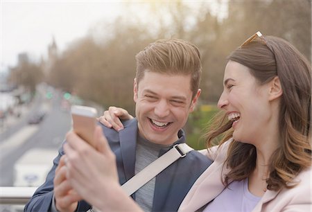 simsearch:6113-08743448,k - Laughing couple taking selfie with camera phone Stock Photo - Premium Royalty-Free, Code: 6113-08985982
