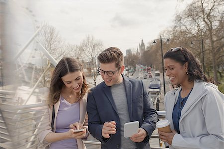 simsearch:6113-06899131,k - Friends using cell phones and drinking coffee on urban bridge, London, UK Stock Photo - Premium Royalty-Free, Code: 6113-08985994