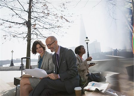 simsearch:6122-07706325,k - Business people meeting, discussing paperwork in sunny urban park Stock Photo - Premium Royalty-Free, Code: 6113-08986066