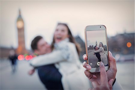 simsearch:6113-06498180,k - Personal perspective, playful couple hugging and being photographed with camera phone near Big Ben, London, UK Stock Photo - Premium Royalty-Free, Code: 6113-08986084
