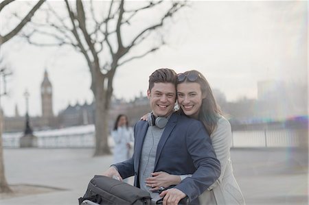 simsearch:6113-07543676,k - Portrait smiling, hugging couple tourists with bicycle in urban park, London, UK Stock Photo - Premium Royalty-Free, Code: 6113-08986094