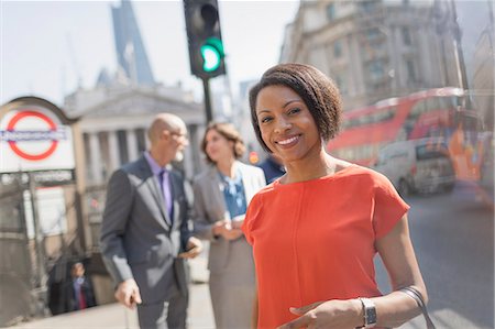 Portrait smiling businesswoman on sunny urban city street, London, UK Stock Photo - Premium Royalty-Free, Code: 6113-08986038