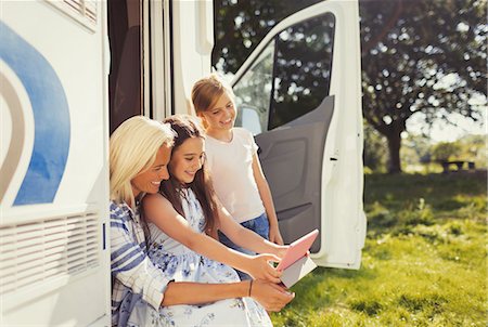 simsearch:6113-07730567,k - Mother and daughters using digital tablet outside sunny motor home Stock Photo - Premium Royalty-Free, Code: 6113-08909856