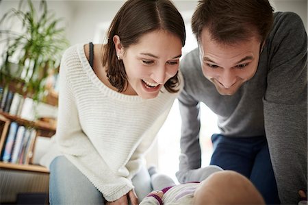 simsearch:6113-06909382,k - Playful parents looking down at baby daughter Stock Photo - Premium Royalty-Free, Code: 6113-08910063
