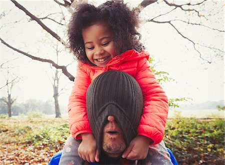 simsearch:649-06623087,k - Playful daughter pulling stocking cap over fathers face in autumn park Stock Photo - Premium Royalty-Free, Code: 6113-08910087