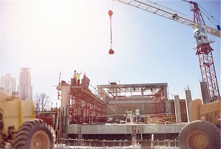 simsearch:6113-07542775,k - Crane over construction workers at sunny construction site Stock Photo - Premium Royalty-Free, Code: 6113-08910019