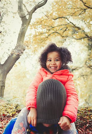 simsearch:649-06623087,k - Portrait smiling daughter pulling stocking cap over fathers head in autumn park Stock Photo - Premium Royalty-Free, Code: 6113-08910155