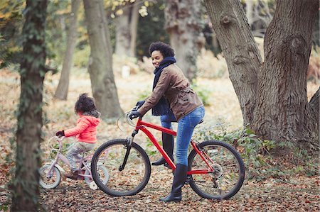simsearch:700-03067843,k - Mother and daughter bike riding in autumn woods Stock Photo - Premium Royalty-Free, Code: 6113-08910182