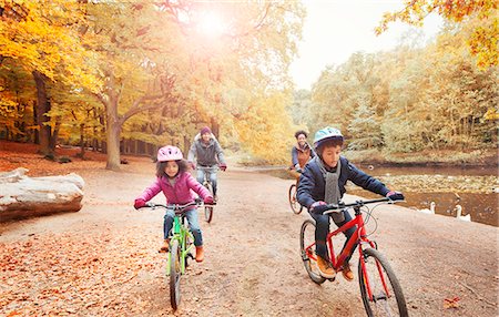 family on bicycle in park - Young family bike riding along pond in autumn park Stock Photo - Premium Royalty-Free, Code: 6113-08910129