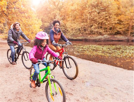 simsearch:700-03067843,k - Young family bike riding along pond in woods Stock Photo - Premium Royalty-Free, Code: 6113-08910137