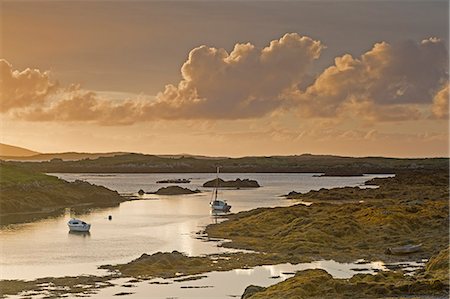 still clouds - Tranquil sunset view fishing boats on lake, Harris, Outer Hebrides Stock Photo - Premium Royalty-Free, Code: 6113-08910221