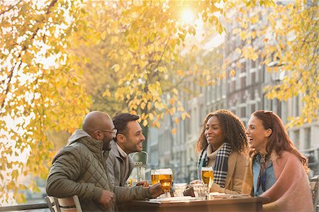 simsearch:6113-07147381,k - Friends drinking beer at outdoor autumn cafe Stock Photo - Premium Royalty-Free, Code: 6113-08927641