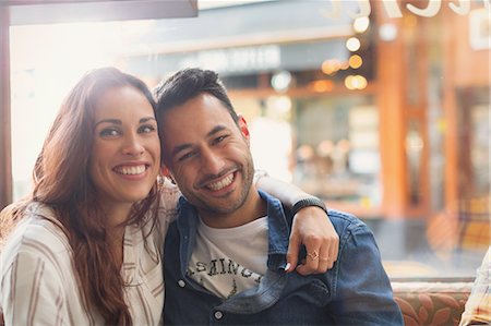 simsearch:6113-07565751,k - Portrait happy young couple hugging in cafe Stock Photo - Premium Royalty-Free, Code: 6113-08927642