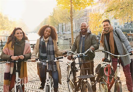 simsearch:6113-07542497,k - Portrait smiling friends bike riding on urban autumn street, Amsterdam Stock Photo - Premium Royalty-Free, Code: 6113-08927681