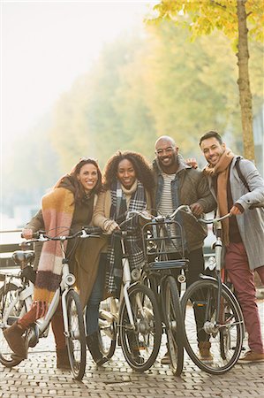 simsearch:6113-07542497,k - Portrait friends bike riding on urban autumn street Stock Photo - Premium Royalty-Free, Code: 6113-08927685