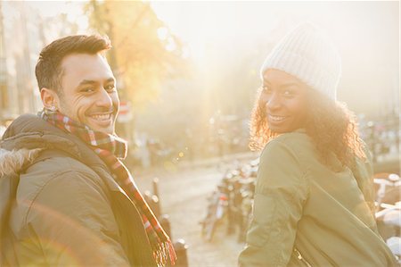 simsearch:6113-07565751,k - Portrait smiling young couple on sunny urban autumn street Stock Photo - Premium Royalty-Free, Code: 6113-08927638