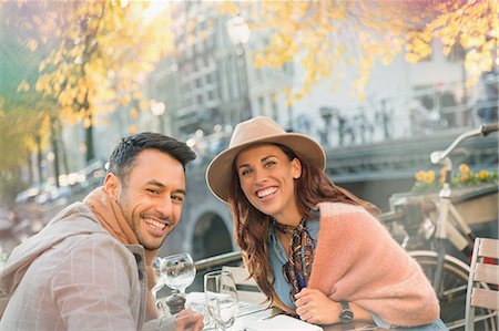 simsearch:6113-07565751,k - Portrait smiling young couple at urban autumn sidewalk cafe Stock Photo - Premium Royalty-Free, Code: 6113-08927781