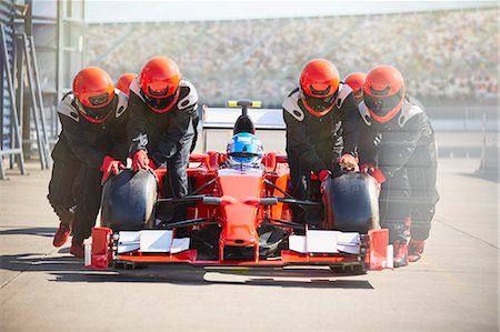 simsearch:632-03403433,k - Pit crew pushing formula one race car out of pit lane Stock Photo - Premium Royalty-Free, Code: 6113-08927795