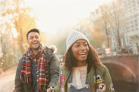 simsearch:859-06808650,k - Laughing young couple walking on urban autumn street, Amsterdam Stock Photo - Premium Royalty-Free, Code: 6113-08927703