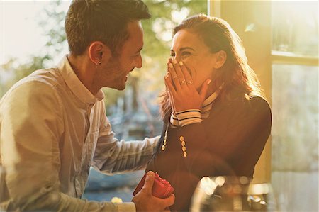 simsearch:700-06553388,k - Boyfriend proposing to surprised, happy girlfriend in cafe Stock Photo - Premium Royalty-Free, Code: 6113-08927709