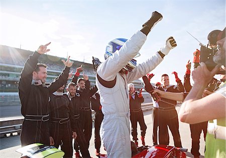 simsearch:6113-06720852,k - Formula one racing team and driver cheering, celebrating victory on sports track Foto de stock - Sin royalties Premium, Código: 6113-08927952