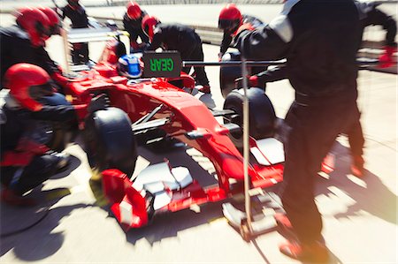 simsearch:700-00546343,k - Pit crew replacing tires on formula one race car in pit lane Stock Photo - Premium Royalty-Free, Code: 6113-08927966