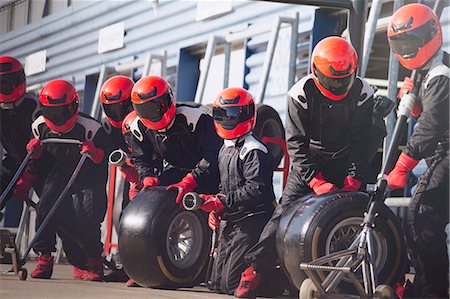 simsearch:700-00546343,k - Pit crew ready with tires in formula one pit lane Stock Photo - Premium Royalty-Free, Code: 6113-08927901