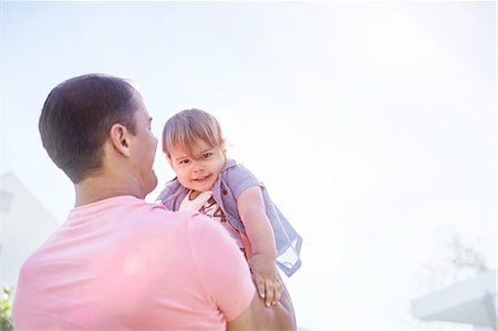 simsearch:6116-07236010,k - Father lifting baby son Stock Photo - Premium Royalty-Free, Code: 6113-08928060