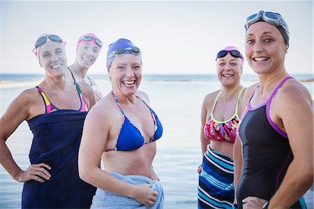 swimmer (female) - Portrait smiling, confident female open water swimmers drying off with towels at ocean Stock Photo - Premium Royalty-Free, Code: 6113-09058366