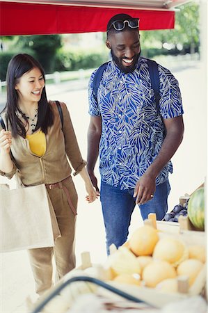 simsearch:6108-05874623,k - Young couple shopping for produce at market storefront Stock Photo - Premium Royalty-Free, Code: 6113-09058545